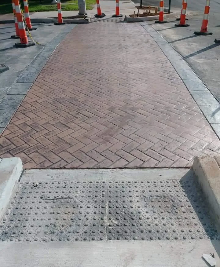 Brick-pattern stamped concrete crosswalk on a commercial street