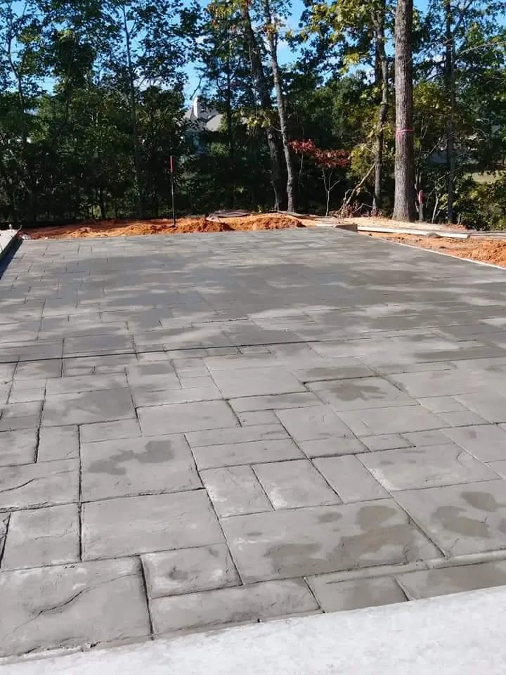 Freshly stamped concrete slab curing
